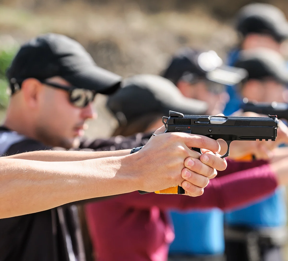 Focused individuals practicing handgun shooting