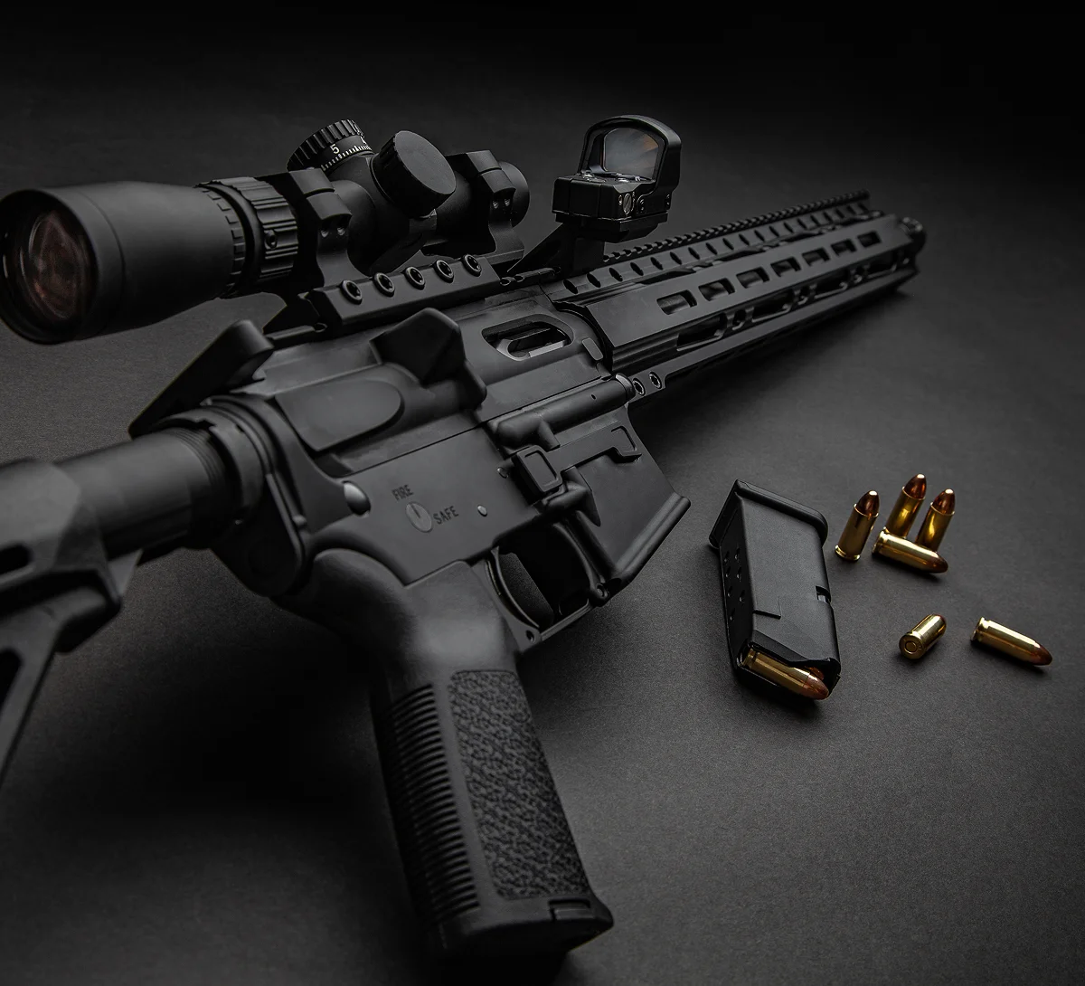 Black rifle, magazine, and scattered bullets