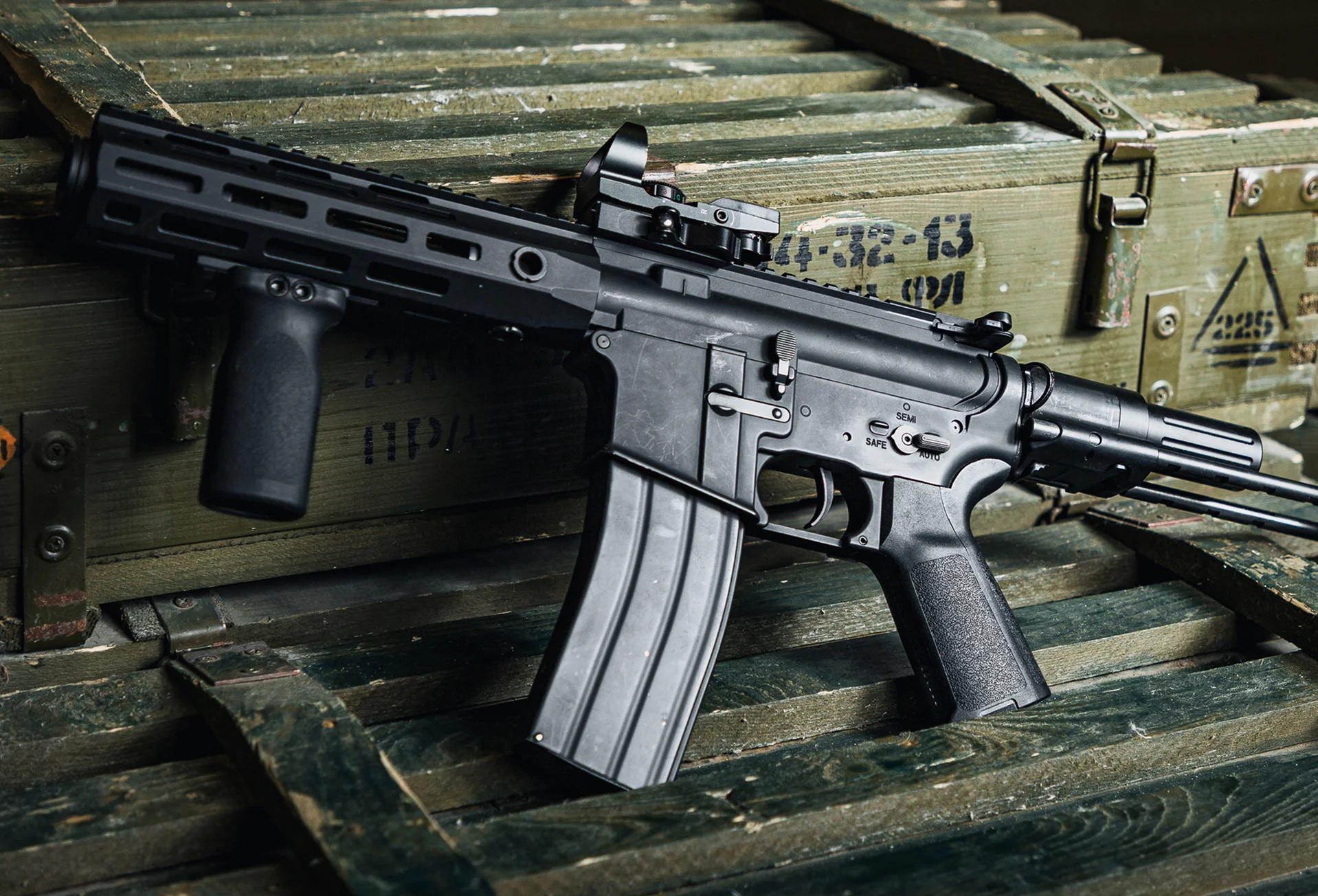 Tactical rifle resting on military boxes